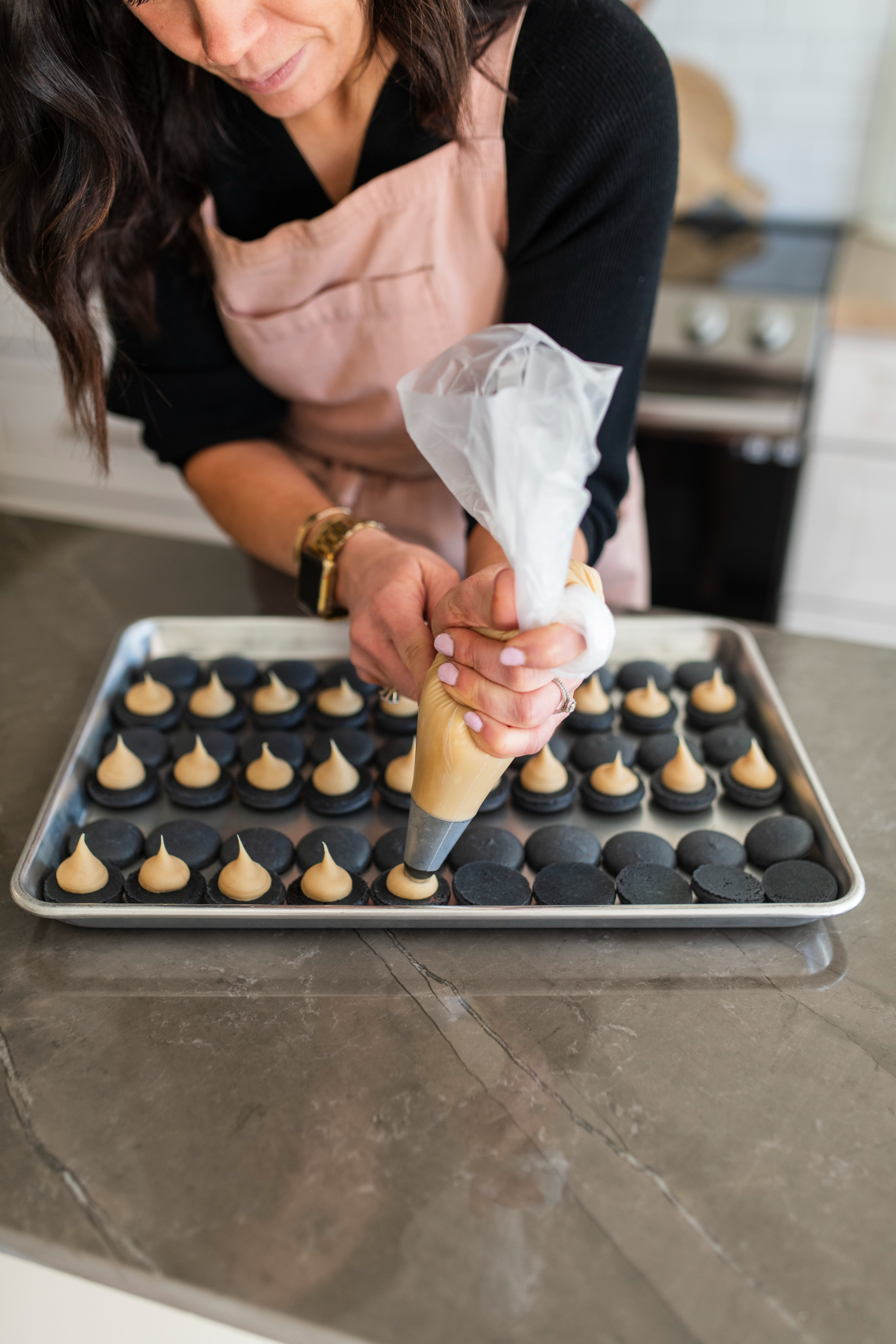 Raina piping macarons by hand